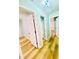 Long hallway with wood-look flooring and access to other areas of the home at 7675 Lanier View Rdg, Cumming, GA 30041