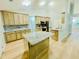 Bright kitchen featuring custom cabinets, modern appliances, and a granite countertop island and backsplash at 7675 Lanier View Rdg, Cumming, GA 30041