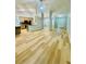 Open floor plan features kitchen with bar and stainless steel appliances, light walls and wood floors at 7675 Lanier View Rdg, Cumming, GA 30041