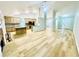Spacious open floor plan with kitchen island that flows into the living room and fireplace at 7675 Lanier View Rdg, Cumming, GA 30041