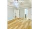 Large main bedroom with entry to bathroom and closet, all featuring wood floors at 7675 Lanier View Rdg, Cumming, GA 30041