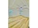 A light filled main bedroom features tray ceilings and light wood floors at 7675 Lanier View Rdg, Cumming, GA 30041