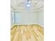 A light filled main bedroom features tray ceilings and light wood floors at 7675 Lanier View Rdg, Cumming, GA 30041