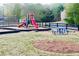 Community playground with slides, picnic table, and open play area provides a fun space for children at 7675 Lanier View Rdg, Cumming, GA 30041