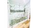 Bright shower with bench seating, dual shower heads, mosaic tile, and pebble stone floors at 7675 Lanier View Rdg, Cumming, GA 30041