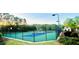 Outdoor tennis and basketball court area in a fenced in area and surrounded by trees and landscaping at 7675 Lanier View Rdg, Cumming, GA 30041