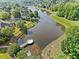 Stunning aerial view of a community lake with dock and lush green surroundings, offering serene waterfront living at 3317 Ridgemill Cir, Dacula, GA 30019