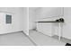 Clean basement with ample workspace, including a built-in workbench with storage cabinets and pegboard organizers at 3317 Ridgemill Cir, Dacula, GA 30019
