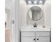 Powder room with white vanity and modern mirror at 3317 Ridgemill Cir, Dacula, GA 30019