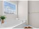 Bright bathroom features a garden tub with a view, perfect for relaxation at 3317 Ridgemill Cir, Dacula, GA 30019