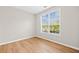 Bright, empty bedroom with wood floors and a window with natural light at 3317 Ridgemill Cir, Dacula, GA 30019
