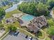 Aerial view of community pool, clubhouse, and playground offers residents a variety of recreational activities at 3317 Ridgemill Cir, Dacula, GA 30019