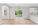 Bright dining area featuring hardwood floors, sliding glass doors to the backyard, and modern lighting at 3317 Ridgemill Cir, Dacula, GA 30019