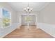 Dining room featuring natural light, chair rail, and decorative pillars at 3317 Ridgemill Cir, Dacula, GA 30019