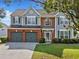 Inviting two-story home features a well-kept lawn, a two-car garage, and a welcoming entrance at 3317 Ridgemill Cir, Dacula, GA 30019