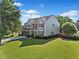 Spacious home with a large front yard, two-car garage, and mature trees under a bright sky at 3317 Ridgemill Cir, Dacula, GA 30019