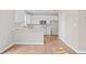 Bright, modern kitchen with white cabinets, stainless steel appliances, and hardwood floors at 3317 Ridgemill Cir, Dacula, GA 30019