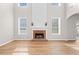 Bright living room features a fireplace, large windows, and wood floors at 3317 Ridgemill Cir, Dacula, GA 30019