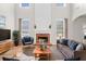 Bright living room with a brick fireplace, large windows, and modern decor at 3317 Ridgemill Cir, Dacula, GA 30019