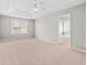 Spacious main bedroom boasts a tray ceiling, neutral carpet, and an ensuite bathroom for added privacy at 3317 Ridgemill Cir, Dacula, GA 30019