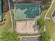 Aerial view of the community sports courts, including a well-maintained basketball court and sand volleyball court at 3317 Ridgemill Cir, Dacula, GA 30019