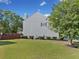 The side yard features lush green grass, mature trees, and a privacy fence, creating a serene outdoor space at 3317 Ridgemill Cir, Dacula, GA 30019