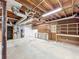 Spacious basement features a built-in workbench and ample storage shelving, offering potential for customization at 1004 Westminister Ct, Woodstock, GA 30188
