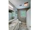 Bathroom featuring granite countertops, modern fixtures, and a shower-tub combo at 1004 Westminister Ct, Woodstock, GA 30188
