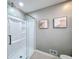 Bathroom showcasing a glass-enclosed shower with tiled walls and decorative artwork at 1004 Westminister Ct, Woodstock, GA 30188
