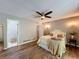 Cozy bedroom with ceiling fan, decorative lighting and hardwood floors at 1004 Westminister Ct, Woodstock, GA 30188