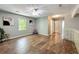 Large bonus room with wood floors, natural light and a unique glass block accent wall at 1004 Westminister Ct, Woodstock, GA 30188