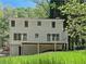 Exterior elevation with a deck overlooking the backyard, and a walkout basement at 1004 Westminister Ct, Woodstock, GA 30188