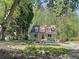 Charming two-story home with a landscaped yard and welcoming front porch and a fire pit at 1004 Westminister Ct, Woodstock, GA 30188