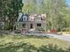Charming two-story home with a landscaped yard, welcoming front porch and fire pit sitting area at 1004 Westminister Ct, Woodstock, GA 30188