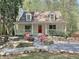 Inviting home featuring a front porch, fire pit area with chairs, and landscaped surroundings at 1004 Westminister Ct, Woodstock, GA 30188