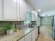 Bright kitchen featuring white cabinets, granite countertops, and stainless steel appliances at 1004 Westminister Ct, Woodstock, GA 30188