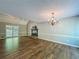 Well-lit living room with hardwood floors, a fireplace, and ample space for entertaining and relaxing at 1004 Westminister Ct, Woodstock, GA 30188