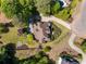 Stunning aerial view of the home with a well-manicured lawn, landscaping, and mature trees at 202 Carrington Estates Ct, Woodstock, GA 30188