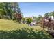Spacious backyard with a fire pit, lush landscaping, and mature trees at 202 Carrington Estates Ct, Woodstock, GA 30188