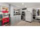 A stylish bar area with a retro refrigerator and cabinetry adds charm to the recreational space at 202 Carrington Estates Ct, Woodstock, GA 30188