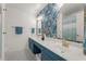Stylish bathroom with double vanity, decorative wallpaper, modern fixtures, and a well-lit space at 202 Carrington Estates Ct, Woodstock, GA 30188