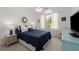 Comfortable bedroom featuring a large window, a ceiling fan and a well-lit space creating a calm atmosphere at 202 Carrington Estates Ct, Woodstock, GA 30188