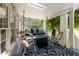 Inviting covered porch featuring a swing, skylight, outdoor seating, and stylish decor at 202 Carrington Estates Ct, Woodstock, GA 30188