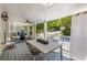 Relaxing covered porch with a swing, dining table, and tranquil outdoor view at 202 Carrington Estates Ct, Woodstock, GA 30188