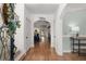 Inviting foyer featuring hardwood floors, a 'welcome' sign and an arched opening to other rooms at 202 Carrington Estates Ct, Woodstock, GA 30188