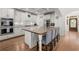 Spacious kitchen with white cabinets, stainless steel appliances, butcher block island, and breakfast bar seating at 202 Carrington Estates Ct, Woodstock, GA 30188