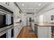 Well-lit kitchen featuring white cabinets, stainless steel appliances, and a butcher block island at 202 Carrington Estates Ct, Woodstock, GA 30188
