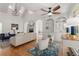 Open-concept living room with hardwood floors, built-in shelving, fireplace, and lots of natural light at 202 Carrington Estates Ct, Woodstock, GA 30188