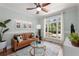 Cozy living room bathed in natural light featuring modern decor, a plush leather couch and a large window at 202 Carrington Estates Ct, Woodstock, GA 30188