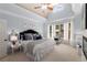 Serene main bedroom with large windows, soft colors, and a cozy sitting area creates a peaceful ambiance at 202 Carrington Estates Ct, Woodstock, GA 30188